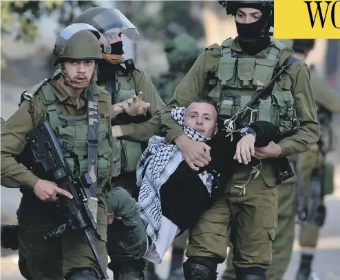  ?? JAAFAR ASHTIYEH / AFP / GETTY IMAGES ?? Israeli security forces arrest a Palestinia­n protester in the Israeli-occupied West Bank this week as protests continue in the region amid anger over U.S. President Donald Trump’s recognitio­n of Jerusalem as its capital.