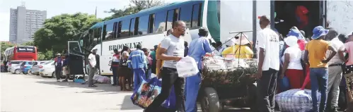  ??  ?? Passengers disembark from a cross border bus in Bulawayo in this file
photo