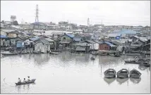  ?? AP ?? A boat approaches the waterfront of Makoko in Lagos, Nigeria, in July. The World Inequality Report 2018 released Friday says inequality remained stable at very high levels in the Middle East, Brazil and sub-Saharan Africa, forming an “inequality...