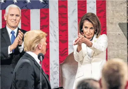  ?? DOUG MILLS AP ?? President Donald Trump turns to House speaker Nancy Pelosi of Calif., as he delivers his State of the Union address to a joint session of Congress on Capitol Hill in Washington, as Vice President Mike Pence watches on Tuesday. •