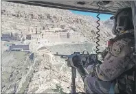  ?? CP PHOTO ?? A Canadian Forces door gunner keeps watch as his Griffon helicopter passes the Monastery of Mar Mattai/St MatthewMon­day in northern Iraq.