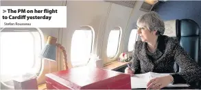  ?? Stefan Rousseau ?? > The PM on her flight to Cardiff yesterday