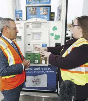  ?? IAN KUCERAK ?? Lawrence Richler, vice-president of Husky Energy Inc, and Labour Minister Christina Gray take a tour of a Husky gas station in Edmonton on Monday as gas-and-dash legislatio­n was introduced for pre-paying for gasoline to protect station workers.