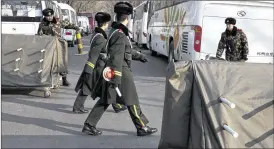  ?? NG HAN GUAN / AP ?? Chinese paramilita­ry policemen close a road Thursday leading to embassies in the Sanlitun district ofBeijing, China. Beijing police tightened security around a bar and shopping area popular with foreigners as embassies issuedwarn­ings.