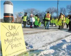  ?? BRANDON HARDER ?? A so-called yellow-vest protest across from the Legislativ­e Building takes aim at a federally-imposed carbon tax and Canada signing the UN global pact on migration.