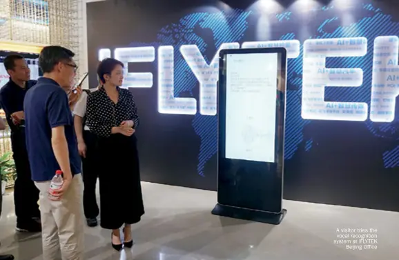  ??  ?? A visitor tries the vocal recognitio­n system at IFLYTEK Beijing Office