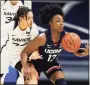  ?? Gary Landers / Associated Press ?? Christyn Williams, right, takes control of a loose ball in front of Xavier guard Shaulana Wagner.