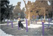  ??  ?? RIGHT
Ms Ren wears a face mask while she works out at Tiantan Park in Beijing. “When I go back home, I disinfect my shoes and take off my coat,” she says.