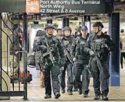  ?? [AP PHOTO] ?? Police officers patrol in the passageway connecting New York City’s Port Authority bus terminal and the Times Square subway station on Tuesday, near the site of Monday’s explosion. Commuters returning to New York City’s subway system on Tuesday were...