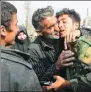  ?? XINHUA ?? A government soldier is embraced by a civilian in Syria’s eastern Ghouta on Sunday.