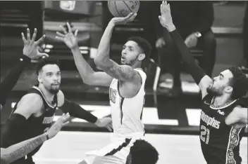  ?? ASSOCIATED PRESS ?? PHOENIX SUNS GUARD CAMERON PAYNE (15) shoots between Memphis Grizzlies guards Dillon Brooks (24) and Tyus Jones (21)in the second half of a game on Monday in Memphis, Tenn.