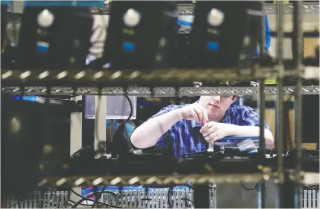  ?? LINDSEY WASSON/REUTERS ?? A Ventec employee works at a plant in Bothell, Wash. The ventilator manufactur­er is seeing a huge increase in demand.