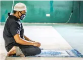  ?? Secretary of National Commission on Muslim Filipinos
AFP ?? I am proud of how all Muslim Filipinos have acted throughout Ramadan under lockdown.
Saidamen Pangarunga­n
An Imam prays at a mosque in Coatabato City on the island of Mindanao ahead of Eid Al-Fitr.