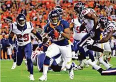  ?? AP ?? Broncos running back C.J. Anderson (22) scores a touchdown against the Houston Texans during the first half on Monday.