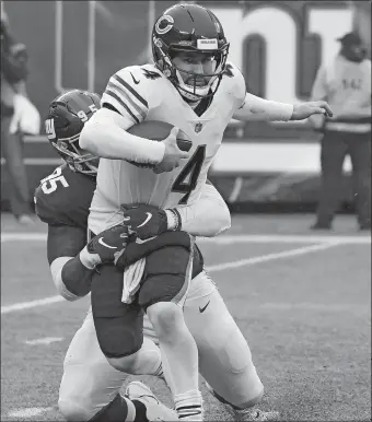  ?? BILL KOSTROUN/AP PHOTO ?? Giants defensive lineman B.J. Hill sacks Chicago’s quarterbac­k Chase Daniel during the first half of Sunday’s game at MetLife Stadium. The Giants won in overtime, 30-27. Hill, a rookie, has a team-leading five sacks for the Giants.