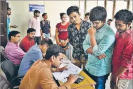  ?? RAJ K RAJ/HT PHOTO ?? Delhi University aspirants fill their admission forms for the new academic session 201819 at the Kirori Mal College on Monday.