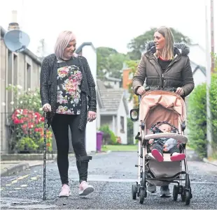  ??  ?? After a stroke, Louise McLuckie, above left, from Carnoustie now walks with a stick and has to rely on the help of family to look after her children.
