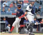  ?? ADAM HUNGER/USA TODAY SPORTS ?? Red Sox outfielder Mookie Betts scores a run against the Yankees in May.