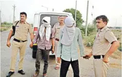  ??  ?? Police take the accused to the scene of the crime where the mutilated body of a woman was dumped after her abduction, gangrape and murder in Rohtak on Sunday