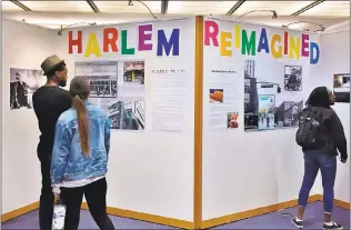  ?? PHOTO BY SAL PIZARRO ?? Students view “Harlem Reimagined,” a new photograph­y exhibition featuring work by San Jose State journalism students, on display at the Dr. Martin Luther King Jr. Main Library.