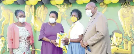  ?? (photos: Jason tulloch) ?? Olivia Grange (second left) minister of culture, gender, entertainm­ent and sport, hands over Samsung tablet devices to Shayanique Neil, student athlete, Guy’s Hill High School. Looking on are Oswald Williams (right), chairman and Joan Davis (left), principal, both of Guy’s Hill High School. The occasion was the handover of Samsung tablet devices at the JADCO office on Wednesday.