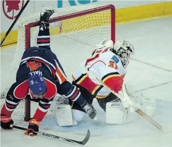  ?? BRUCE EDWARDS/EDMONTON JOURNAL ?? Oilers forward Taylor Hall, left, is upended on a breakaway on Calgary goalie Karri Ramo.