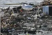  ?? Luis Sinco Los Angeles Times ?? A SEABIRD picks through plastic and other debris deposited in Long Beach by the Los Angeles River.