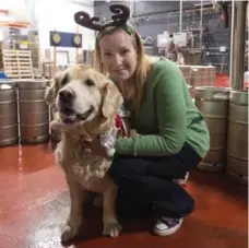  ?? ANDREW LAHODYNSKY­J PHOTOS ?? Callaie Naftolin with her six-year-old Golden Retriever Beauford, who has attended each of the events as part of his “bucket list.” He was diagnosed with terminal cancer in March. Naftolin said that since attending the events, his doctors are “stumped” because his tumours have stopped growing.