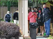  ?? HYOSUB SHIN/HYOSUB.SHIN@AJC.COM ?? Young people and their families line up to wait in the drizzling rain at Dekalb Pediatric Center for their first dose of COVID-19 vaccine in Decatur. Their first jab would be the Pfizer vaccine, the only one approved for their age group thus far.