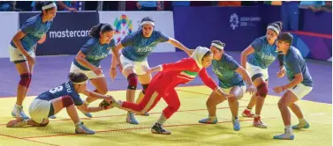  ?? PTI ?? Indian women’s kabaddi team players tackle down an Iranian raider in their final match in Jakarta on Friday. India lost to Iran narrowly by a 24- 27 verdict to finish with a silver medal. —