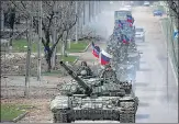  ?? REUTERS ?? An armoured convoy of pro-Russian troops moves along a road in the southern port city of Mariupol on Thursday.