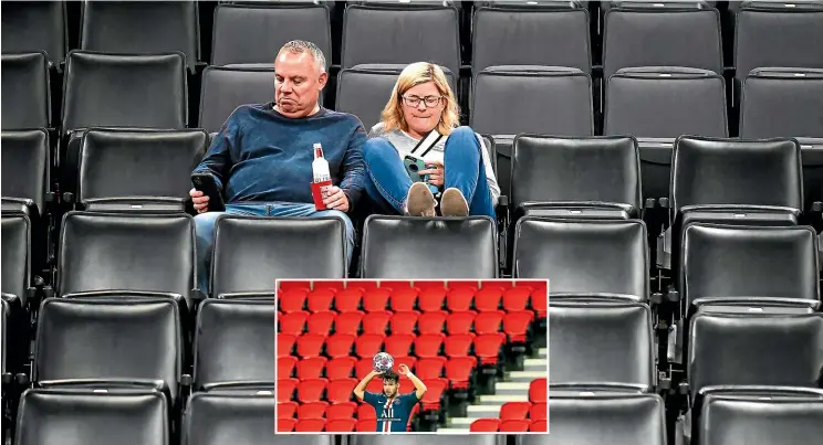  ?? AP ?? Two fans sit in a vacant section of the stadium after the Oklahoma-Utah NBA game was called off at short notice; inset, a Champions League football game in Paris was played in an empty arena.