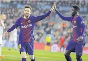  ?? EPA ?? Barcelona’s Lionel Messi, left, celebrates with Ousmane Dembele.