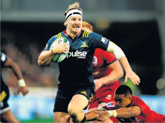  ?? Picture / Photosport ?? Highlander­s loose forward James Lentjes charges towards the goal line to score against the Reds last night in Dunedin. Sonny Bill Williams