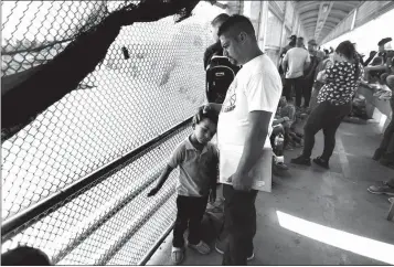  ?? ASSOCIATED PRESS ?? ASYLUM SEEKERS wait for U.S. authoritie­s to reopen a legal port of entry between Matamoros, Mexico, and Brownsvill­e, Texas, after the bridge was closed briefly by U.S. authoritie­s during a protest by migrants. Mexican gangs have adapted quickly to the new reality of masses of vulnerable migrants parking in the heart of their fiefdom, experts say.