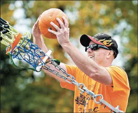  ??  ?? Tim Miller loads a pumpkin into his slingshot In“Tim”idator during Saturday’s event in Valparaiso.