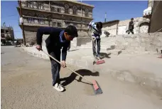  ?? EPA ?? Volunteers in Sanaa take part in a clean-up campaign in response to depleted public services across the capital