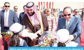  ?? — AFP ?? ISMAILIA, Egypt: Egyptian President Abdel Fattah Al-Sisi (right) and Saudi Crown Prince Mohammed bin Salman receive flowers as they visit the Suez Canal on Monday.