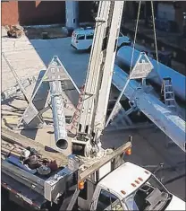  ?? | CARRIE NAPOLEON ?? Workers ready 50-foot sections of the 200-foot E-911 communicat­ions tower going up at the Lake County Government Center in Crown Point.