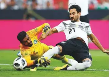  ?? Reuters ?? Saudi Arabia’s Abdullah Al Maiouf scrambles as Germany’s Ilkay Gundogan attempts to score during an internatio­nal friendly at BayArena, on Friday.