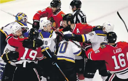  ?? NAM Y. HUH/THE ASSOCIATED PRESS ?? St. Louis and Blackhawks scuffle after the Blues defeated the Blackhawks 4-3 in Game 4 of their first-round Stanley Cup playoff series Tuesday in Chicago. The Blues have a 3-1 series lead and can finish off the Blackhawks in Game 5 Thursday night in St. Louis.