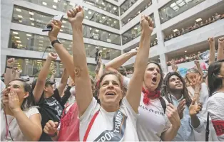  ??  ?? Hundreds of activists protest the Trump administra­tion’s approach to illegal border crossings and separation of children from immigrant parents Thursday in the Hart Senate Office Building on Capitol Hill.