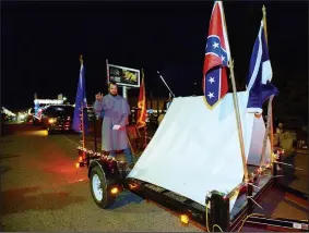  ?? NWA Democrat-Gazette/ANDY SHUPE ?? One of the 70 entries for the 22nd annual Christmas Parade of the Ozarks on Saturday night was by the Arkansas Sons of Confederat­e Veterans. The float drew some complaints.