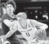  ?? ABBIE PARR/GETTY IMAGES ?? Rex Pflueger of Notre Dame works against Parker Stewart of Pitt during the second half Monday in New York.