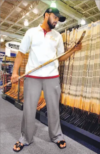  ?? TONY BOCK/TORONTO STAR ?? Faisal Saeed Al Suwaidi marvels over the selection of sticks at a Scarboroug­h store yesterday.