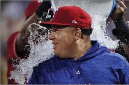  ?? Brandon Wade ?? The Associated Press Texas Rangers starting pitcher Bartolo Colon is doused after his 246th career win, the most by a pitcher born in Latin America, on Tuesday in Arlington, Texas.