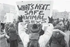  ?? DARREN CALABRESE/The Canadian Press ?? A demonstrat­or holds up a sign in front of Queen’s Park to protest
Ontario’s new sex education curriculum in Toronto on Tuesday.