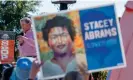  ?? Photograph: Erik S Lesser/EPA ?? Republican Brian Kemp at a rally in Alpharetta, Georgia last week, as an Abrams supporter holds up a sign.