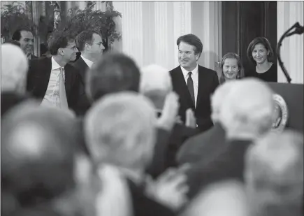  ?? DOUG MILLS / THE NEW YORK TIMES ?? Judge Brett Kavanaugh, President Donald Trump’s nominee for the Supreme Court, winks to someone in the crowd as he arrives Monday in the East Room of the White House in Washington. During his 12 years on the Court of Appeals for the District of...