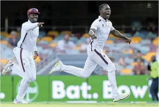  ?? /Bradley Kanaris/Getty Images ?? Enthrallin­g contest: Shamar Joseph of the West Indies celebrates victory after taking the wicket of Australia’s Josh Hazlewood.